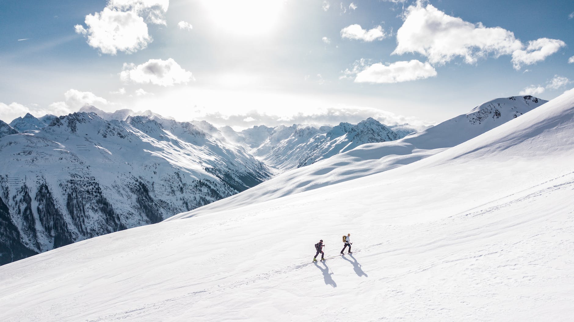 two men hiking on a snowy mountain